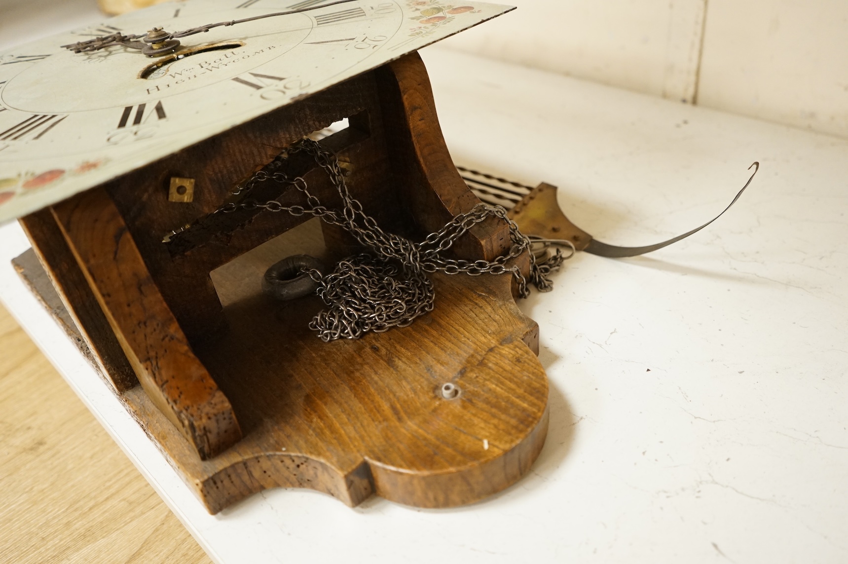 A 19th century wall clock with pendulum and weight, the floral dial inscribed Wm Ball, High Wycombe
